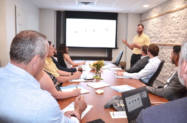 Skyline Energy team member Matt Kennedy presenting report in office meeting room