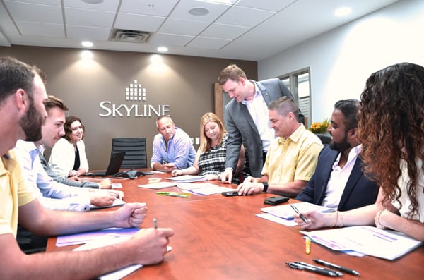 Skyline Energy President Rob Stein in a boardroom with Skyline Energy staff